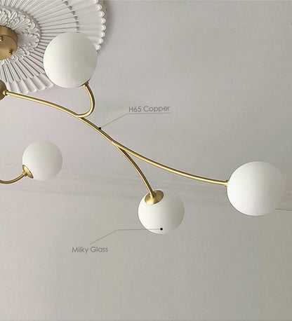 Golden Bloom chandelier with gold-tone branches and milky glass globes